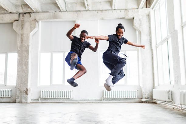 two black men dancing together at dance lesson in exercise room
